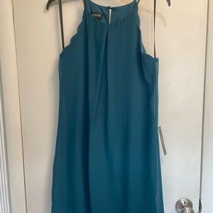 Cute teal flowey dress with scalloped neckline!